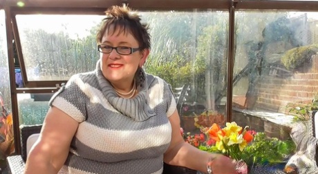Short haired BBW in glasses Rita shows her huge breasts and masturbates