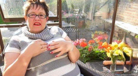 Short haired BBW in glasses Rita shows her huge breasts and masturbates