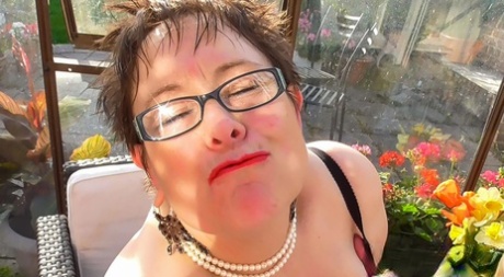 Short haired BBW in glasses Rita shows her huge breasts and masturbates