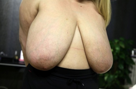 Chubby blonde Dalila lets out her magnificent breasts and flaunts them