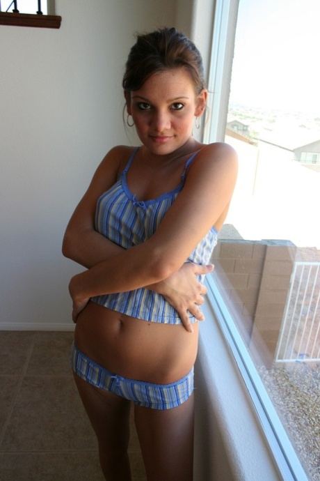 Glamorous amateur teen Katie stripping and posing naked by the window