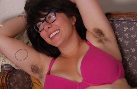 Nerdy amateur brunette Cleo shows her big tits and touches her furry crotch