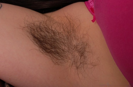 Nerdy amateur brunette Cleo shows her big tits and touches her furry crotch