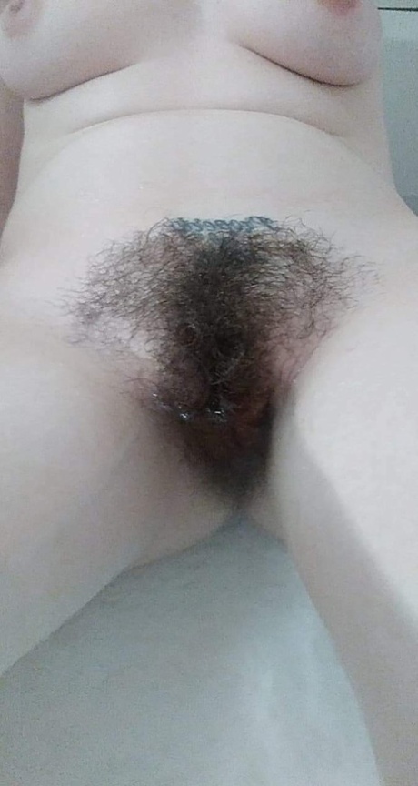 Amateur honey with big tits Amanda Marks teases with her bushy pussy in a tub