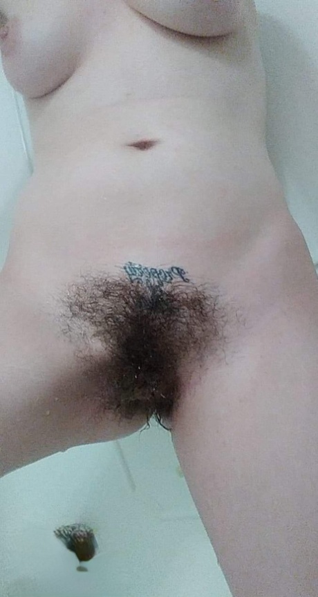Amateur honey with big tits Amanda Marks teases with her bushy pussy in a tub