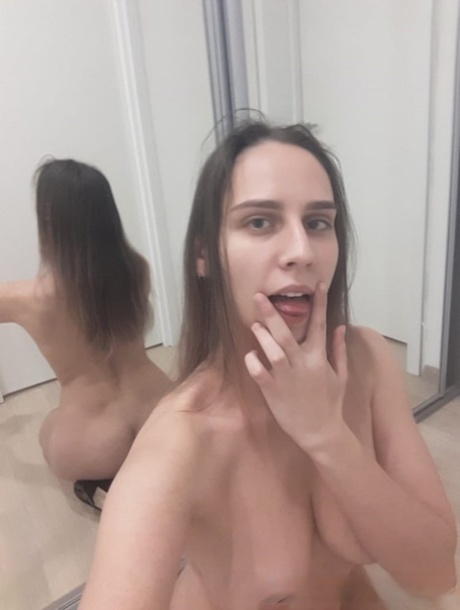 Naughty amateur babe poses naked in the mirror and shows her juicy tits