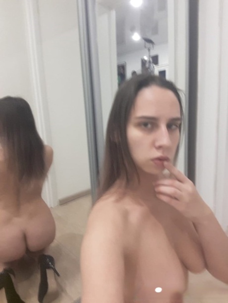Naughty amateur babe poses naked in the mirror and shows her juicy tits