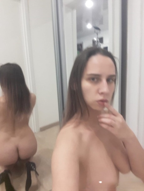 Naughty amateur babe poses naked in the mirror and shows her juicy tits