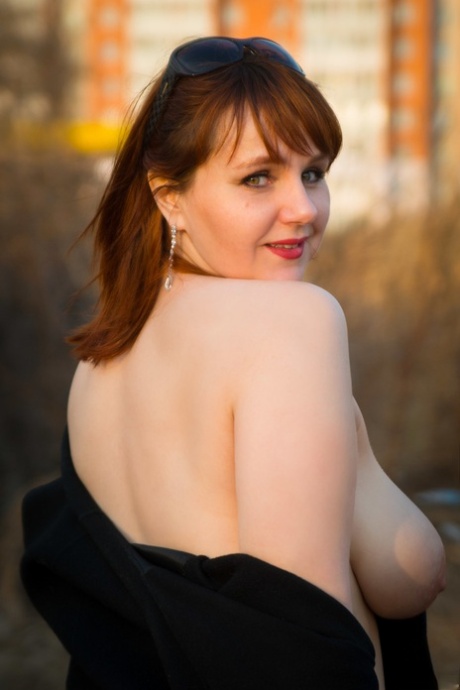 Fat MILF Katrin Porto teases with her big tits and poses in stockings outdoors