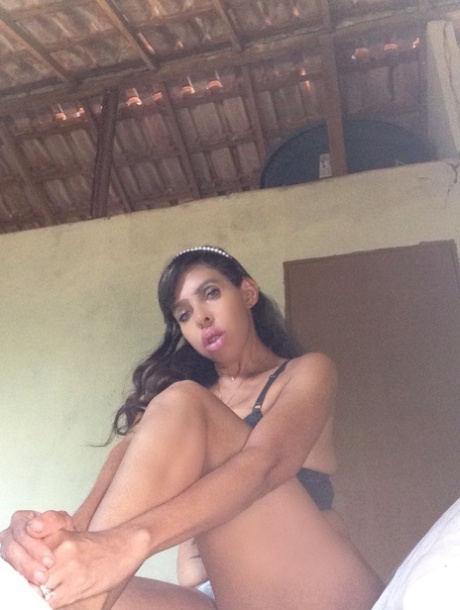 Curvy Latina Carla Brazil lets out her big tits and flaunts her ass at home