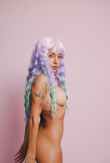 Colorful beauty Camila Luna poses naked and sticks a glass dildo in her twat