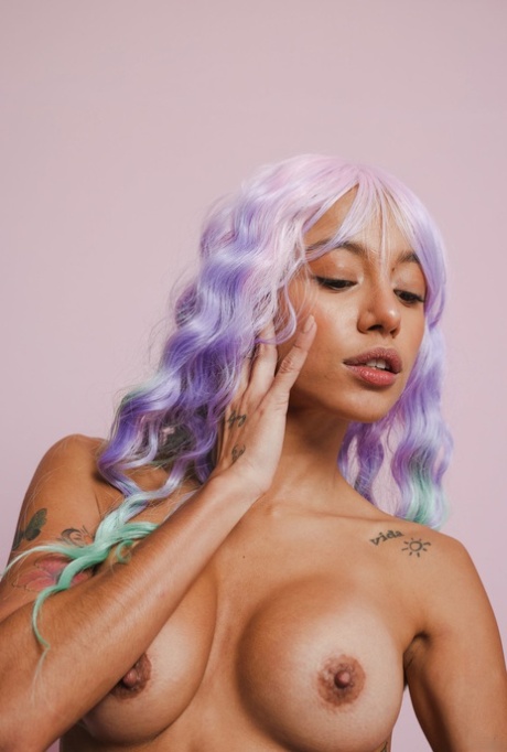 Colorful beauty Camila Luna poses naked and sticks a glass dildo in her twat