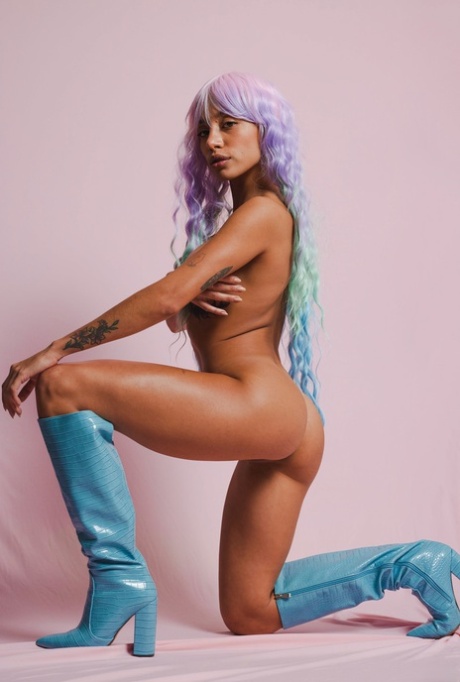 Colorful beauty Camila Luna poses naked and sticks a glass dildo in her twat