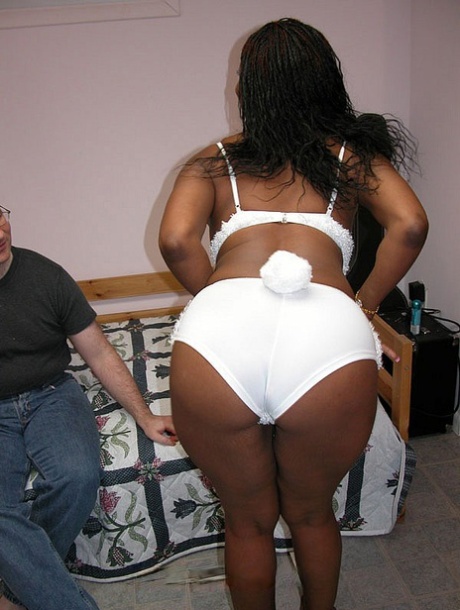 Ebony babe Honey fondles her big tits and takes a white knob deeply