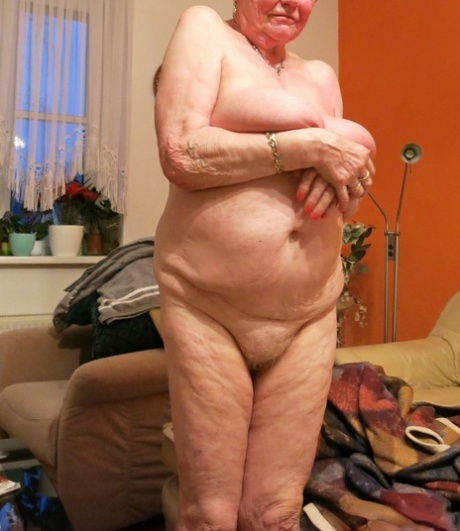Short-haired granny Oma Geil strips and shows off her big saggy boobs