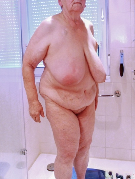 Chubby granny Lavinia strips completely naked and shows her saggy tits