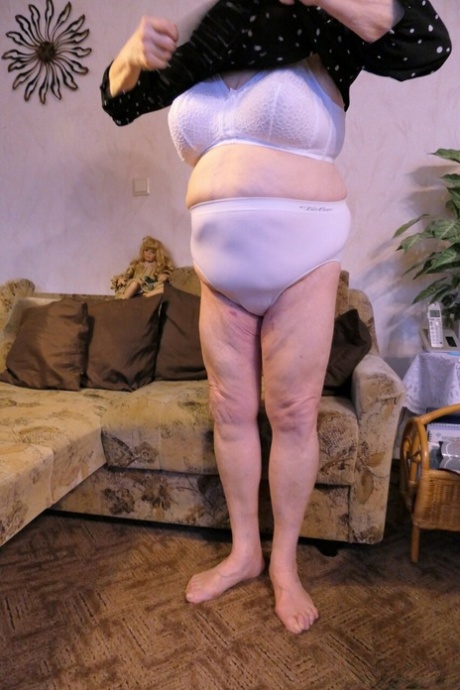 Granny with red lipstick Bagra undresses and displays her big saggy tits