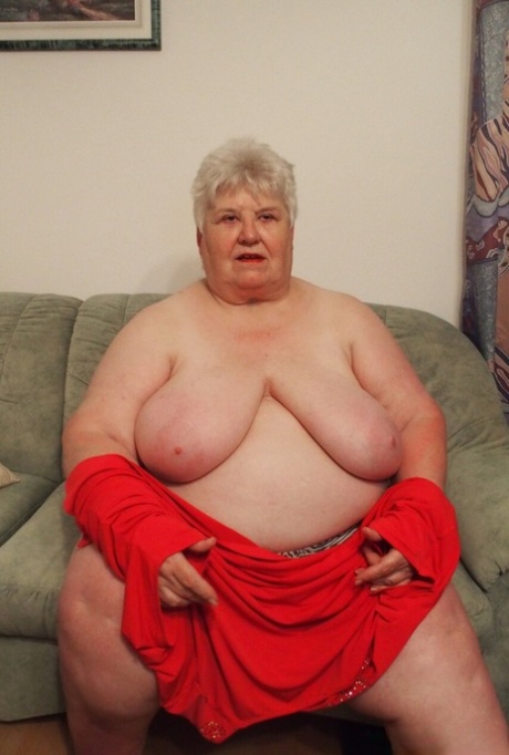 Fat granny Akula shows off her huge saggy tits while changing in a solo