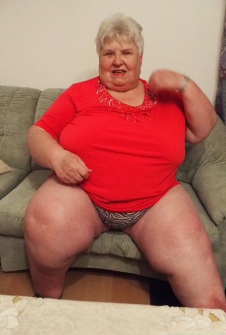 Fat granny Akula shows off her huge saggy tits while changing in a solo
