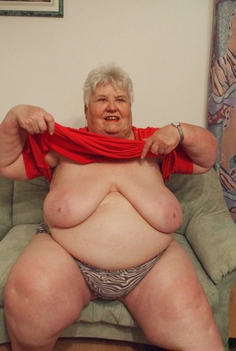 Fat granny Akula shows off her huge saggy tits while changing in a solo