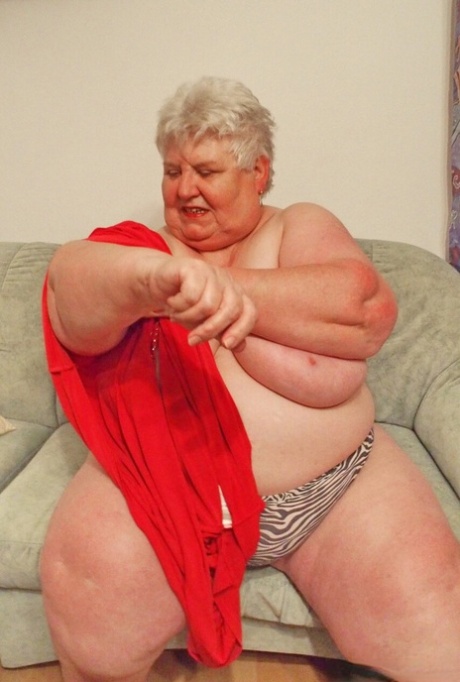 Fat granny Akula shows off her huge saggy tits while changing in a solo