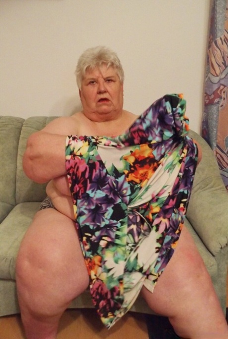Fat granny Akula shows off her huge saggy tits while changing in a solo