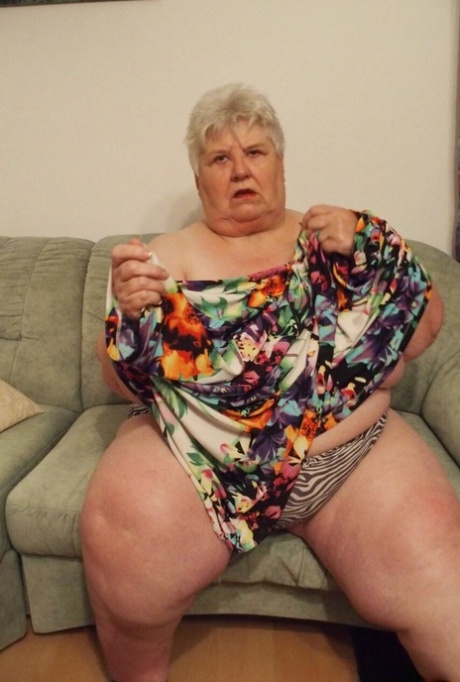 Fat granny Akula shows off her huge saggy tits while changing in a solo