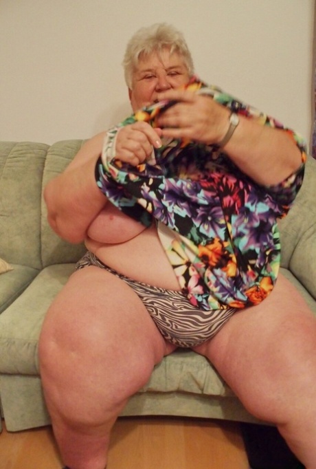 Fat granny Akula shows off her huge saggy tits while changing in a solo
