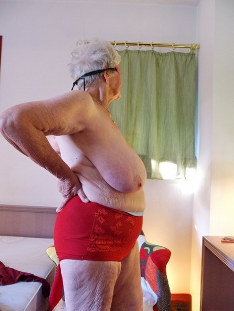 Short-haired granny Medora goes topless and shows her huge saggy tits