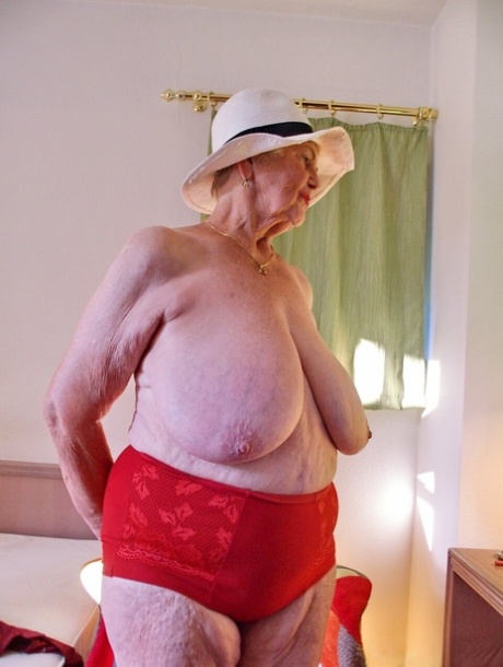 Short-haired granny Medora goes topless and shows her huge saggy tits