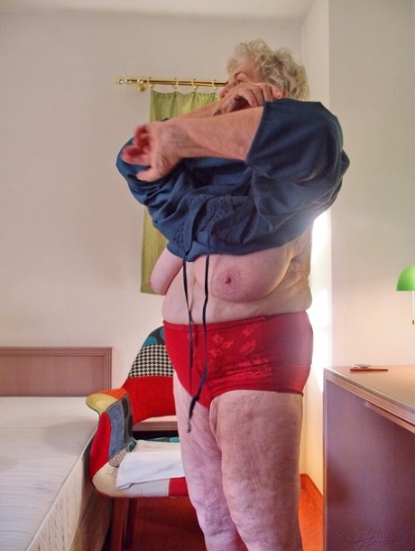 Short-haired granny Medora goes topless and shows her huge saggy tits
