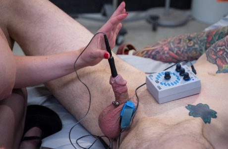 Busty redhead Mz Berlin sounding her sex slave's dick with an electric device