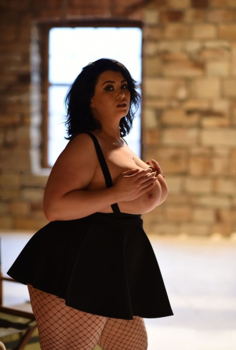 Chubby gorgeous lady Kiki lets out her massive juggs wearing a short skirt